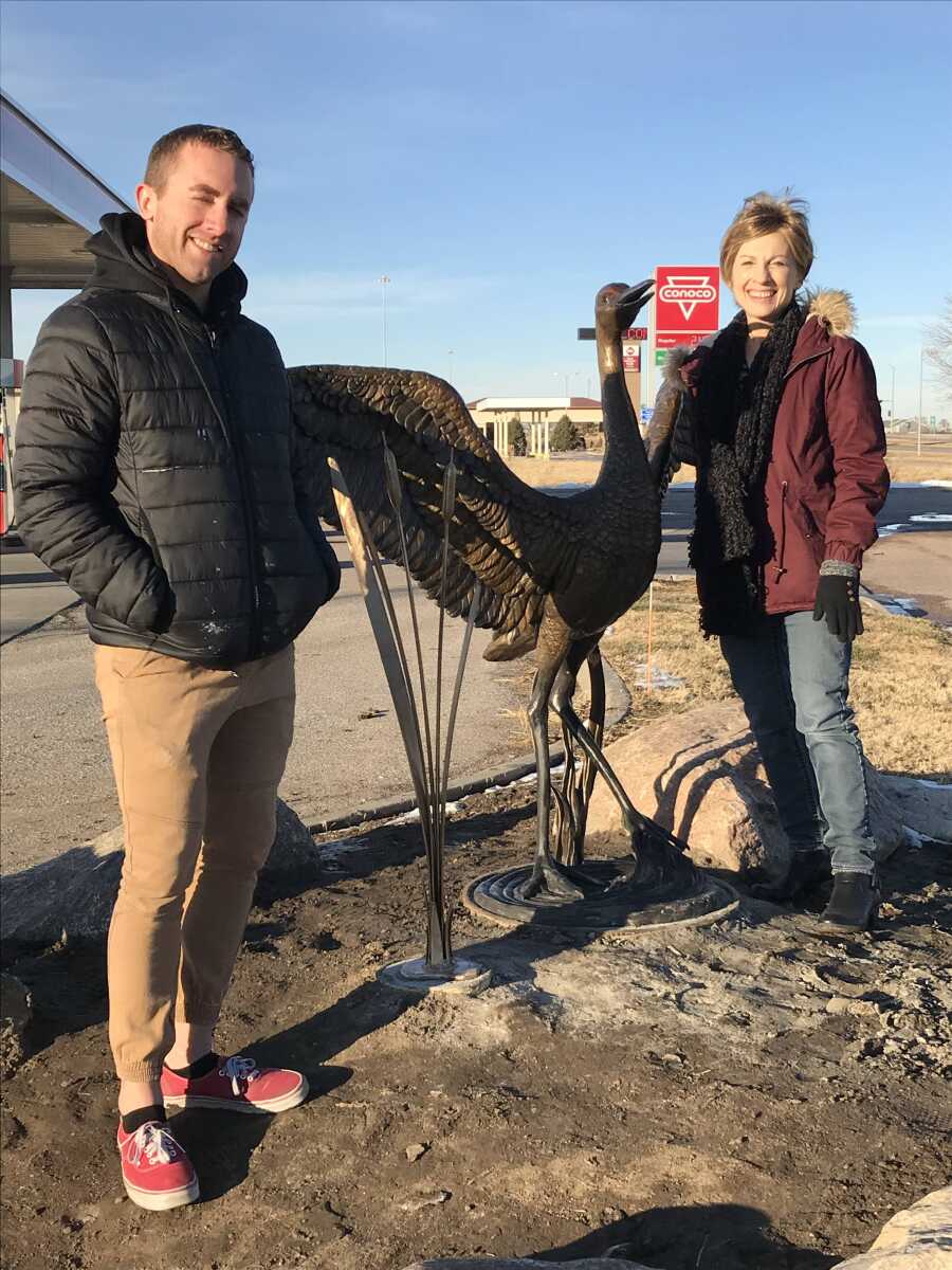 Joe McHale and Sondra Jonson, with Jonson’s sandhill crane bronze at the south entrance to Kearney.